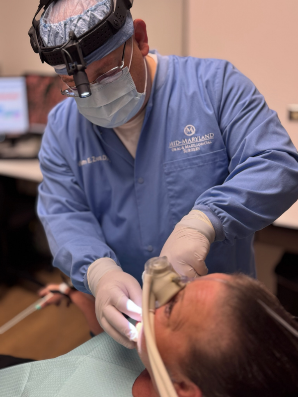 Oral surgeon in Frederick, MD working on patient.