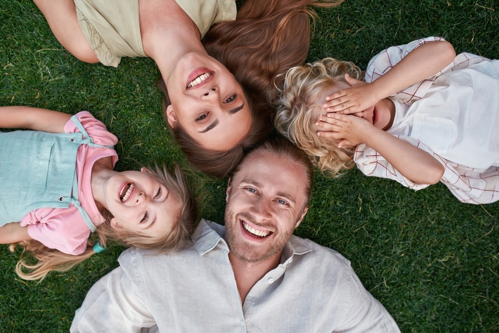 Smiling family enjoying healthy happy moments after treatment with an oral surgeon in Frederick, MD